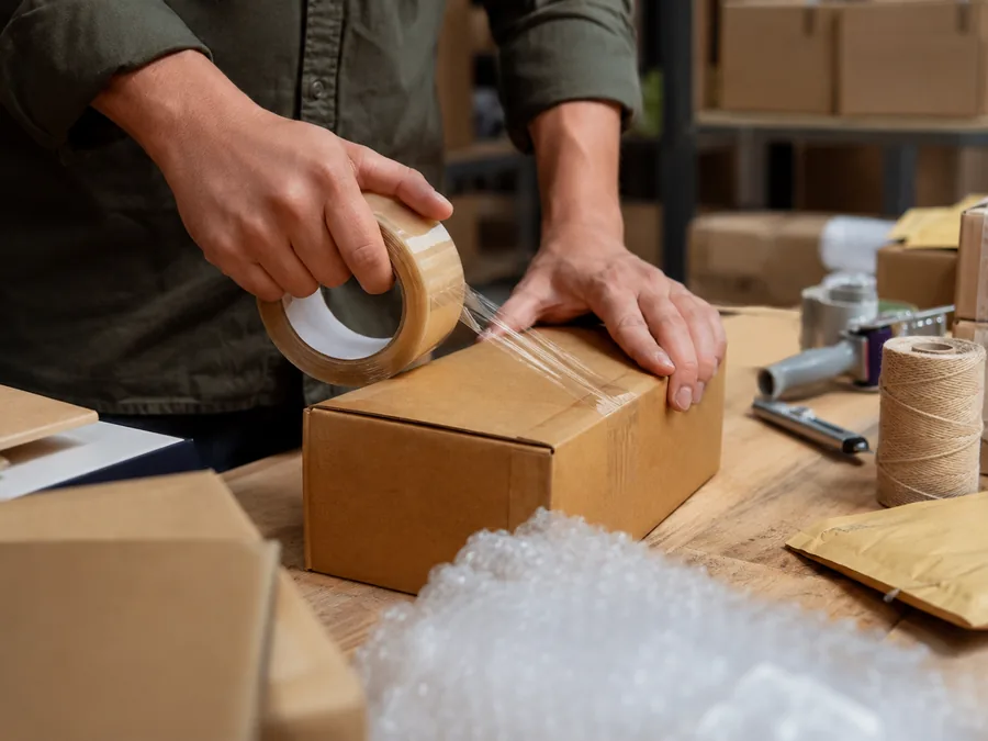 Bir paketleme masasında sevkiyata hazırlanan kargolar